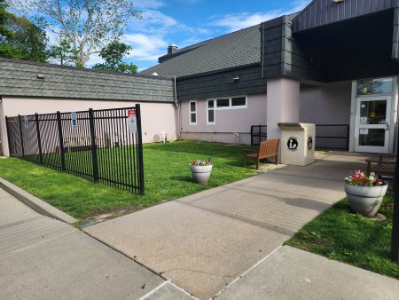 View of area to be turned into a play area from the sidewalk by the front door.
